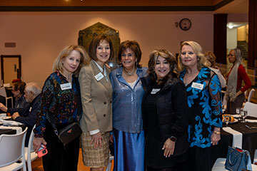 A group of women stand close together, waiting for the camera to capture their photo. Links to Ages 60–70  A group of women stand close together, waiting for the camera to capture their photo. Links to Ages 60–70