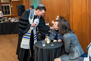 A rabbi places his hand on an elderly woman's shoulder as they chat. Links to Gifts by Will A rabbi places his hand on an elderly woman's shoulder as they chat. Links to Gifts by Will