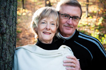 A man and his wife stand together in the woods. Links to Beneficiary Designations