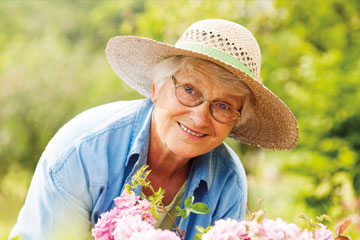 A woman smiles as she tends to her flowers. Links to Gifts That Protect Your Assets A woman smiles as she tends to her flowers. Links to Gifts That Protect Your Assets